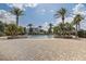 Resort-style pool area surrounded by lush landscaping and palm trees at 3067 Princewood Dr, Minneola, FL 34715