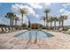 Sparkling community pool with sun loungers and lush palm trees at 3067 Princewood Dr, Minneola, FL 34715