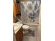 Bathroom with a shower-tub combo, a pedestal sink, and a decorative shower curtain at 310 Knoll Pl, The Villages, FL 32162
