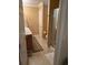 Bathroom featuring double sinks, a shower with glass doors, and a neutral color scheme at 310 Knoll Pl, The Villages, FL 32162