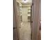 Walk-in closet featuring custom shelving and drawers, illuminated by a ceiling light fixture at 310 Knoll Pl, The Villages, FL 32162