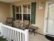Inviting front porch with comfortable seating and charming shutters, perfect for enjoying the outdoors at 310 Knoll Pl, The Villages, FL 32162