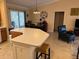 Open kitchen features a breakfast bar that overlooks the dining area, making it a great space to entertain at 310 Knoll Pl, The Villages, FL 32162