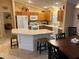 Well-equipped kitchen with an island, modern appliances, and easy access to dining and living areas at 310 Knoll Pl, The Villages, FL 32162