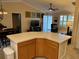 Spacious kitchen with a breakfast bar and open layout that connects to the living and dining areas at 310 Knoll Pl, The Villages, FL 32162