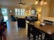 Comfortable living room with large windows and ample seating, seamlessly connected to the dining and kitchen areas at 310 Knoll Pl, The Villages, FL 32162