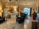 Open-concept living room seamlessly flowing into the kitchen and dining area, creating an inviting space at 310 Knoll Pl, The Villages, FL 32162