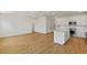Open living space featuring hardwood floors, a kitchen, and a blank canvas at 8323 Sw 58 Loop, Ocala, FL 34481