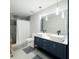 Modern bathroom with double sink vanity and tiled shower with glass door at 12844 Oulton Cir, Orlando, FL 32832