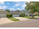 Charming single Gathering home featuring three car garage and well-manicured lawn at 12844 Oulton Cir, Orlando, FL 32832