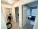 Bright hallway featuring tile flooring, chandelier, and doors to rooms at 12844 Oulton Cir, Orlando, FL 32832