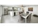 Bright kitchen with stainless steel appliances, center island with a beverage cooler and a stylish dining table at 12844 Oulton Cir, Orlando, FL 32832
