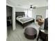 Spacious bedroom with a ceiling fan, a plush chair and carpet, and large windows at 12844 Oulton Cir, Orlando, FL 32832