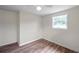 Bedroom showcasing natural light and wood-look flooring at 1740 Inman Nw Dr, Winter Haven, FL 33881
