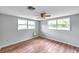 Bright bedroom featuring wood floors and large windows at 1740 Inman Nw Dr, Winter Haven, FL 33881