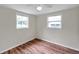Bright bedroom with two windows and wood-look flooring at 1740 Inman Nw Dr, Winter Haven, FL 33881