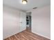 Bedroom with wood-look flooring and view to kitchen at 1740 Inman Nw Dr, Winter Haven, FL 33881