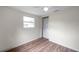 Bedroom with window and wood-look flooring at 1740 Inman Nw Dr, Winter Haven, FL 33881