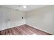 This bedroom has wood-look flooring and a ceiling fan at 1740 Inman Nw Dr, Winter Haven, FL 33881