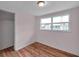 Bedroom with window, closet, and wood-look floors at 1740 Inman Nw Dr, Winter Haven, FL 33881