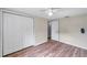 Bedroom featuring a ceiling fan, closet doors, and wood-look flooring at 1740 Inman Nw Dr, Winter Haven, FL 33881