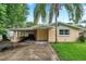 Charming single-story home featuring a covered parking area and mature trees at 1740 Inman Nw Dr, Winter Haven, FL 33881