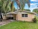 Charming single-story home with a covered parking area and lush landscaping at 1740 Inman Nw Dr, Winter Haven, FL 33881