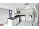 Bright kitchen featuring white cabinets, black countertops, and stainless steel appliances at 1740 Inman Nw Dr, Winter Haven, FL 33881