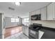 Open kitchen with stainless steel appliances and a view of the living area at 1740 Inman Nw Dr, Winter Haven, FL 33881