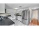 Updated kitchen features stainless steel appliances and white cabinetry at 1740 Inman Nw Dr, Winter Haven, FL 33881