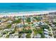 Aerial shot of a beach community with a home in the center, and walking path outlined to the ocean at 64 Alberta Ave, Ponce Inlet, FL 32127