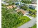 Aerial view of a home featuring a pool, well-maintained landscaping, and mature trees at 64 Alberta Ave, Ponce Inlet, FL 32127