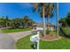 Charming single-story home with well-manicured lawn and a stone paver driveway, enhanced by mature palm trees at 64 Alberta Ave, Ponce Inlet, FL 32127