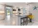 Open-concept kitchen with island, breakfast bar, modern lighting, and stainless steel appliances at 64 Alberta Ave, Ponce Inlet, FL 32127