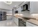 Bright kitchen featuring white cabinets, stainless steel appliances, and modern countertops at 64 Alberta Ave, Ponce Inlet, FL 32127