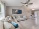 Bright living room features tile flooring, neutral colors, a comfortable sectional sofa, and lots of natural light at 64 Alberta Ave, Ponce Inlet, FL 32127