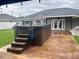 Backyard with hot tub on patio and string lights, perfect for outdoor relaxation at 7144 Remington Oaks Loop, Lakeland, FL 33810
