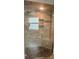 Tiled shower featuring glass door, pebble floor, and dual showerheads at 7144 Remington Oaks Loop, Lakeland, FL 33810