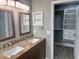 Bathroom featuring double vanity and large walk-in closet at 7144 Remington Oaks Loop, Lakeland, FL 33810
