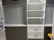Walk-in closet featuring custom shelving and drawer system for optimal organization at 7144 Remington Oaks Loop, Lakeland, FL 33810