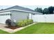 Exterior shot showcasing a well-kept yard and a white privacy fence, adding seclusion to the property at 7144 Remington Oaks Loop, Lakeland, FL 33810