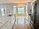Well-lit kitchen featuring stainless steel appliances, granite countertops, and a breakfast nook at 7144 Remington Oaks Loop, Lakeland, FL 33810