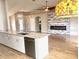 Open-concept kitchen featuring granite countertops and a modern electric fireplace in the living area at 7144 Remington Oaks Loop, Lakeland, FL 33810