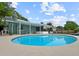 Outdoor area with a refreshing blue swimming pool, patio, and covered seating at 1238 Honeytree E Ln, Lakeland, FL 33801