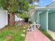 Landscaped backyard includes a pool filtration area and an outdoor shower at 1238 Honeytree E Ln, Lakeland, FL 33801