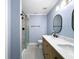 Bathroom showcasing double sinks, modern fixtures, and a glass-enclosed shower at 1238 Honeytree E Ln, Lakeland, FL 33801