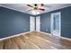 Bedroom showcasing wood-look flooring, crown molding, and ample natural light at 1238 Honeytree E Ln, Lakeland, FL 33801