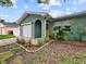 Charming home with landscaped front yard, attached garage, and a bright yellow front door at 1238 Honeytree E Ln, Lakeland, FL 33801