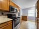 Bright kitchen boasting stainless steel oven and microwave, with tile flooring and neutral wall colors at 1238 Honeytree E Ln, Lakeland, FL 33801