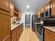 Open-concept kitchen with granite countertops, stainless steel appliances, and stylish backsplash, ready for cooking at 1238 Honeytree E Ln, Lakeland, FL 33801